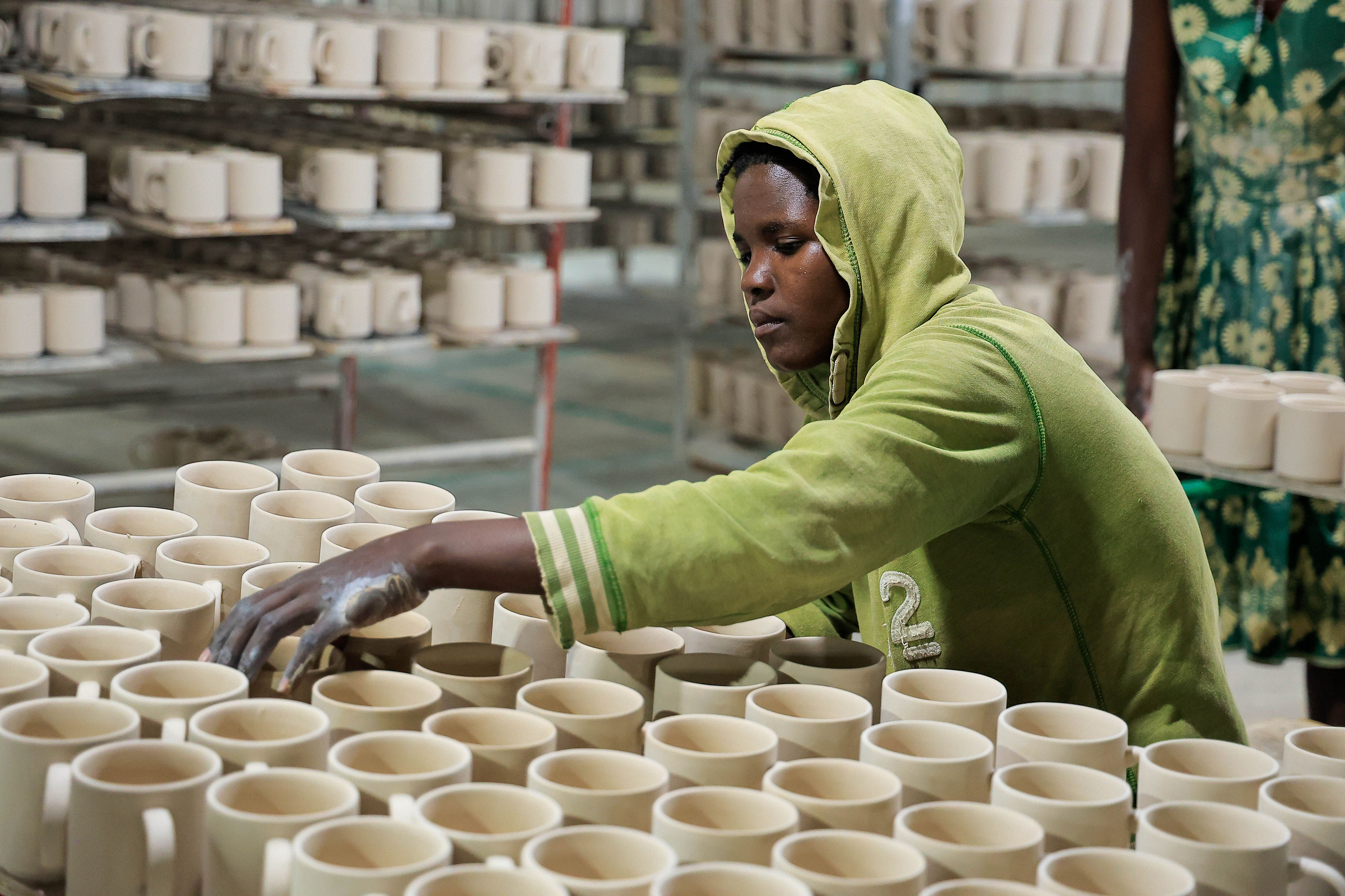 A worker assembling items at one of the work stations 
